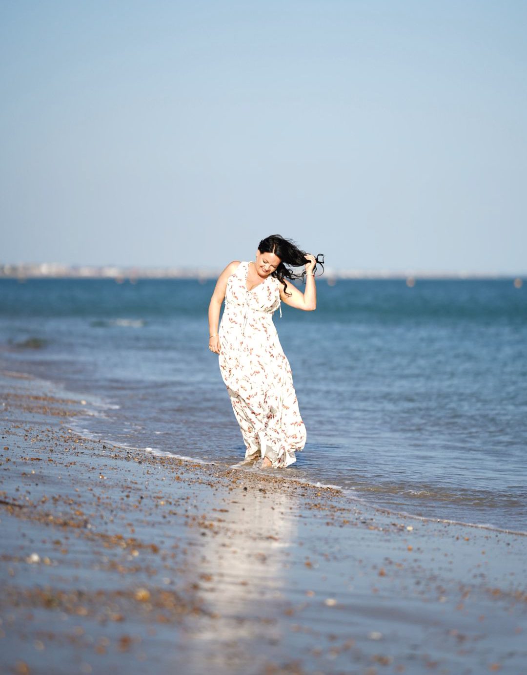 Bernadett of Soul Harmony Life Coaching walking on the beach, feeling serene and empowered.